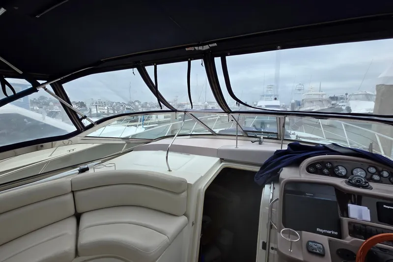 Slide: The Image of Interior view of a 2002 Regal Commodore 4260 yacht, featuring helm and seating area. - 30