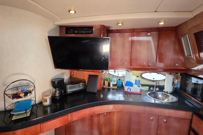 Slide: The Image of Luxurious 2002 Regal Commodore 4260 yacht interior with modern kitchen amenities. - 45