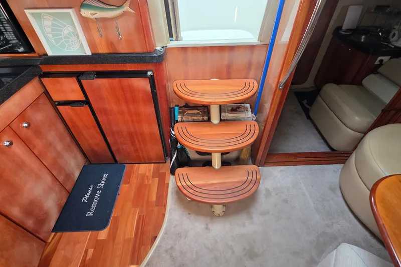 Slide: The Image of Interior of 2002 Regal Commodore 4260 yacht with wooden steps and kitchen area. - 46