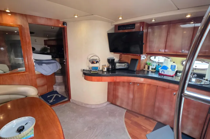 Slide: The Image of Luxurious 2002 Regal Commodore 4260 yacht interior with modern kitchen and cozy living space. - 48