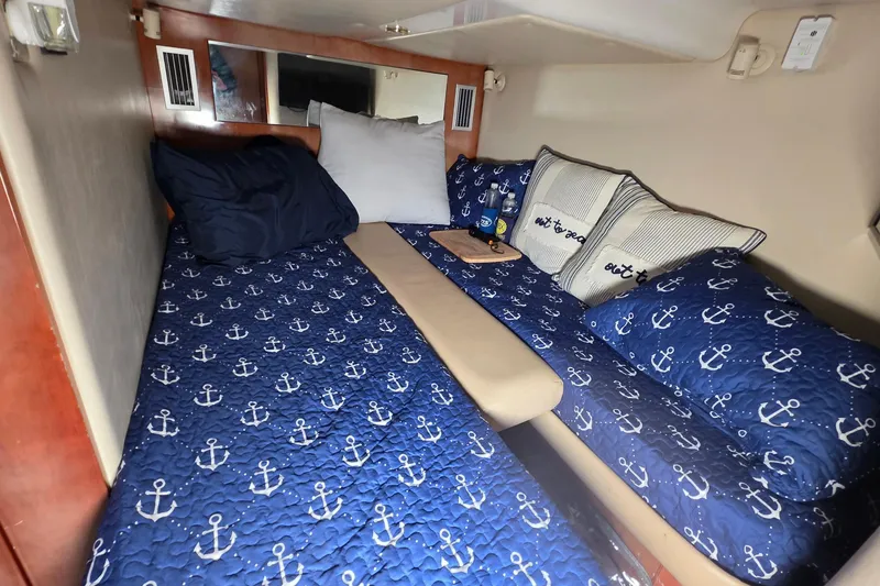 Slide: The Image of Cozy cabin interior of 2002 Regal Commodore 4260 with nautical-themed bedding. - 52
