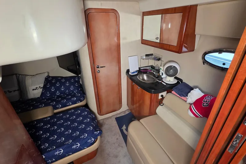 Slide: The Image of Interior of 2002 Regal Commodore 4260 yacht with cozy cabin and kitchenette. - 53