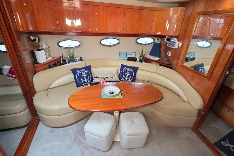 Slide: The Image of Luxurious interior of 2002 Regal Commodore 4260 yacht with leather seating and wooden accents. - 55