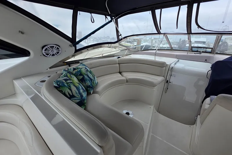 Slide: The Image of Luxurious 2002 Regal Commodore 4260 yacht interior with plush seating and tropical cushions. - 56