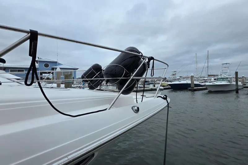 Slide: The Image of 2002 Regal Commodore 4260 yacht docked at marina with cloudy sky. - 6