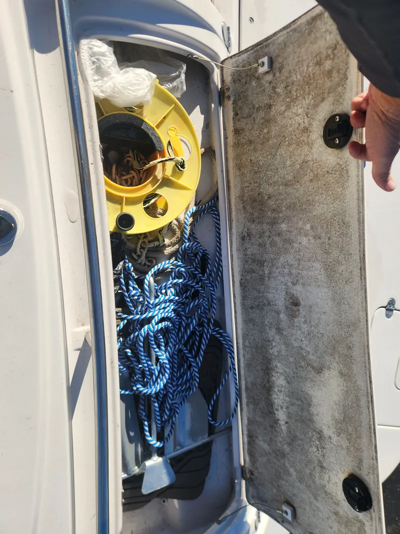 Slide: The Image of Storage compartment of 2005 Four Winns 214 Funship with rope and accessories. - 11