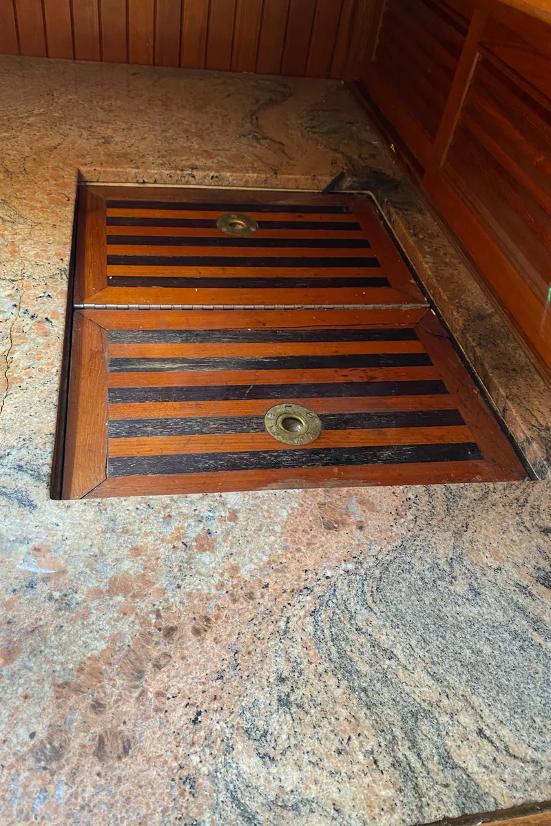 Slide: The Image of Wooden hatch on granite countertop, Hans Christian 38 Mark II, 1981 yacht interior. - 12