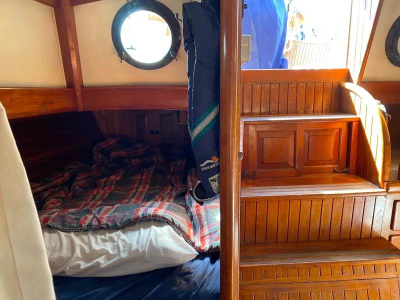 Slide: The Image of Cozy cabin interior of 1981 Hans Christian 38 Mark II sailboat with wooden stairs and bedding. - 14