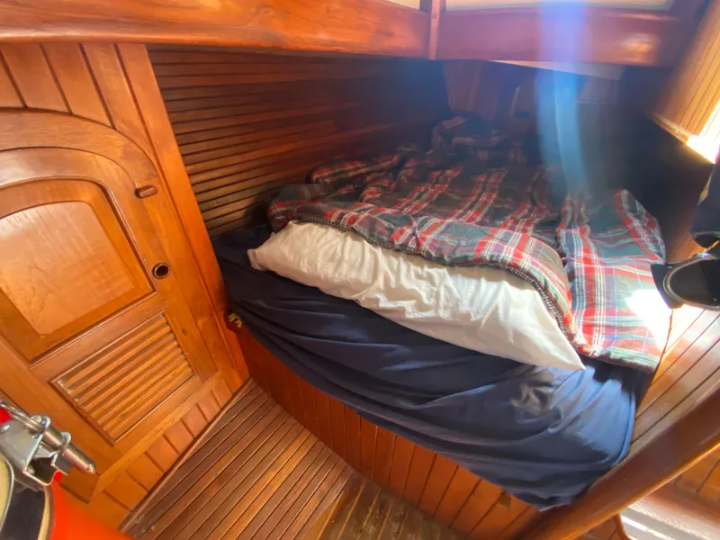 Slide: The Image of Cozy cabin interior of 1981 Hans Christian 38 Mark II sailboat with plaid bedding. - 15