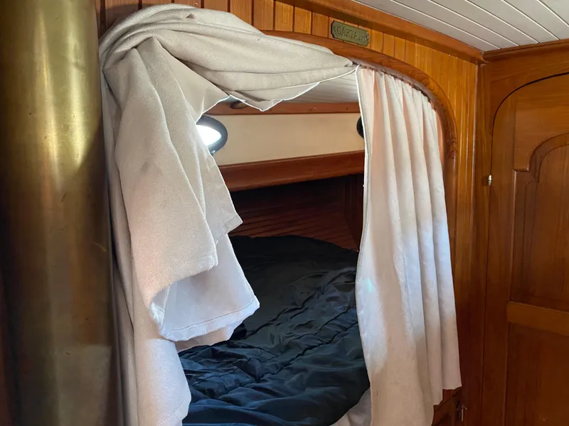 Slide: The Image of Cozy cabin interior of 1981 Hans Christian 38 Mark II sailboat with wooden finish and curtains. - 16