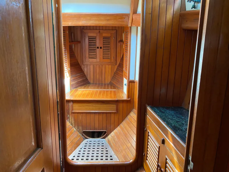 Slide: The Image of Interior of 1981 Hans Christian 38 Mark II sailboat with wooden paneling and cabinetry. - 18