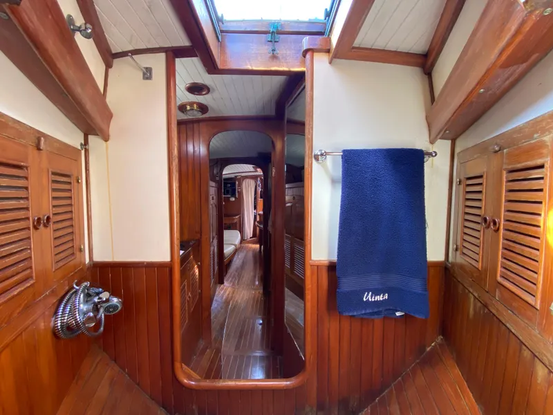 Slide: The Image of Interior of 1981 Hans Christian 38 Mark II sailboat with wooden paneling and blue towel. - 19