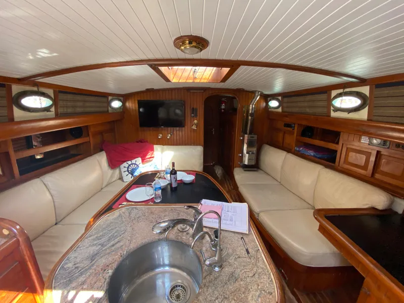 Slide: The Image of Interior of 1981 Hans Christian 38 Mark II yacht with elegant wood finish and cozy seating. - 2