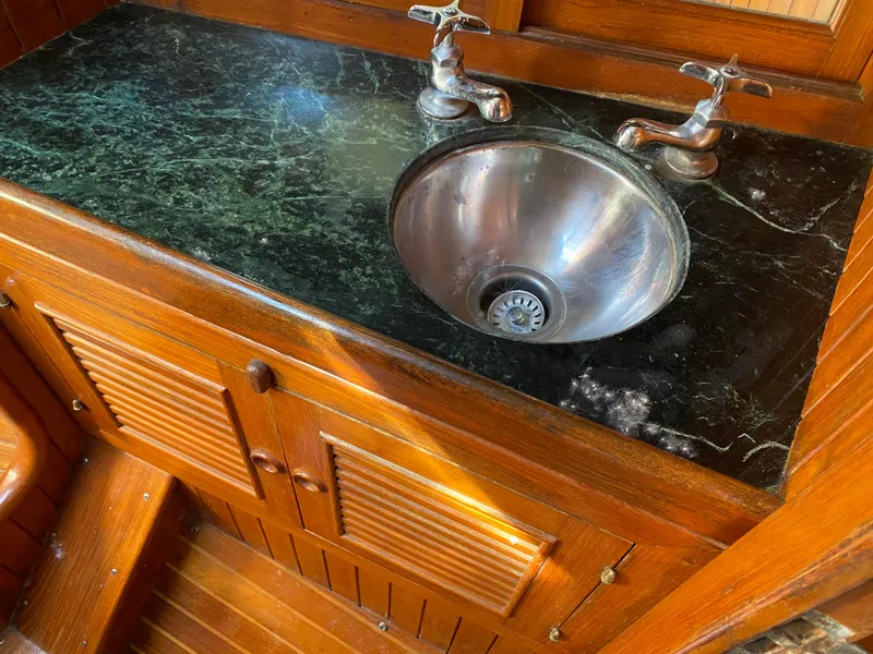Slide: The Image of Wooden boat interior with marble countertop and stainless steel sink, Hans Christian 38 Mark II, 1981. - 20