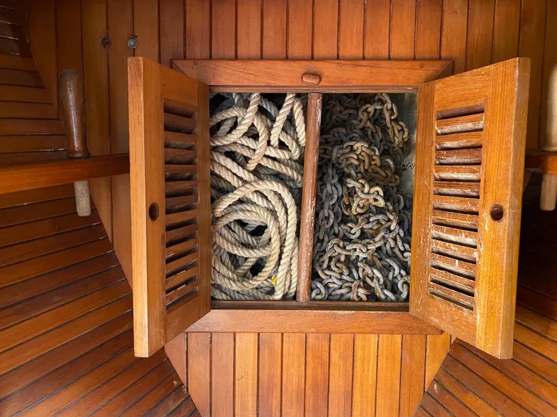 Slide: The Image of Wooden cabinet on Hans Christian 38 Mark II yacht, storing coiled ropes and chains. - 24