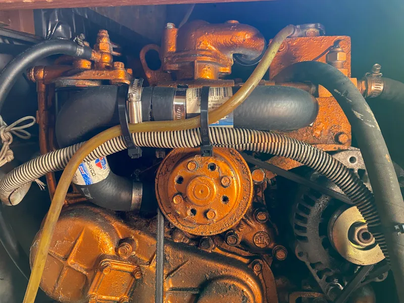 Slide: The Image of 1981 Hans Christian 38 Mark II engine with visible hoses and components. - 26