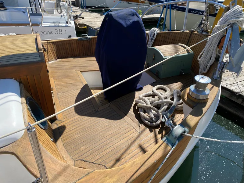 Slide: The Image of 1981 Hans Christian 38 Mark II sailboat deck with ropes and covered equipment. - 27