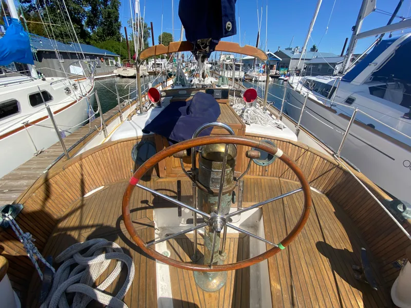 Slide: The Image of Cockpit of 1981 Hans Christian 38 Mark II sailboat with wooden deck and steering wheel. - 29