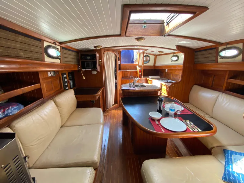 Slide: The Image of Interior of 1981 Hans Christian 38 Mark II sailboat with cozy seating and dining area. - 3