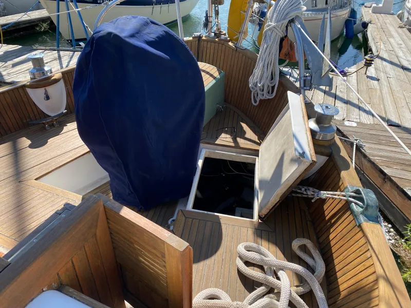 Slide: The Image of 1981 Hans Christian 38 Mark II sailboat deck with open hatch and coiled ropes. - 38
