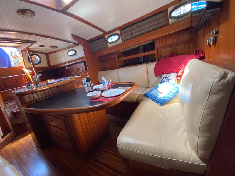 Slide: The Image of Interior of 1981 Hans Christian 38 Mark II sailboat with cozy dining area and wooden finishes. - 4