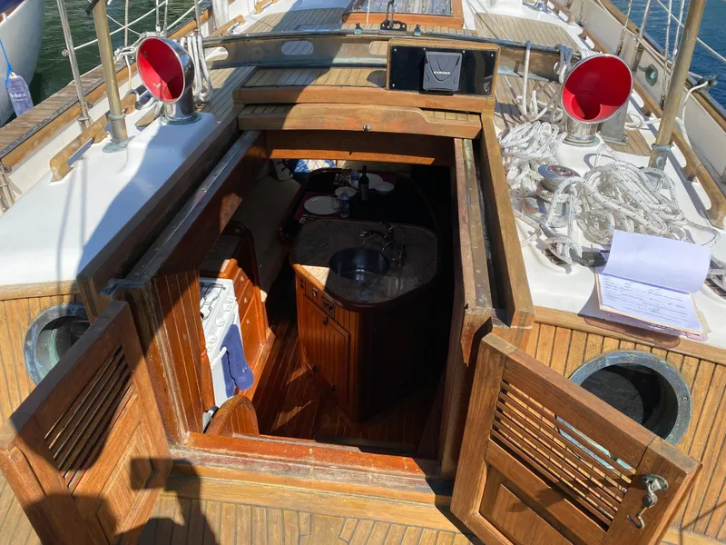 Slide: The Image of 1981 Hans Christian 38 Mark II sailboat interior with wooden hatch and nautical equipment. - 40