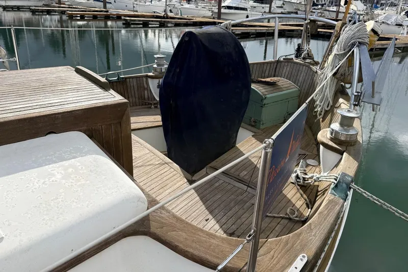 Slide: The Image of 1981 Hans Christian 38 Mark II sailboat deck with wooden finish, docked at marina. - 68