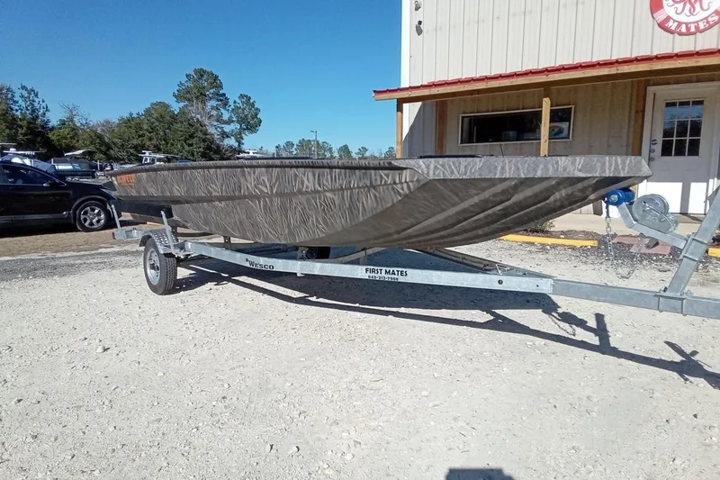 Slide: The Image of 2026 Alweld 1756 Invader boat on trailer, parked outside a building. - 4