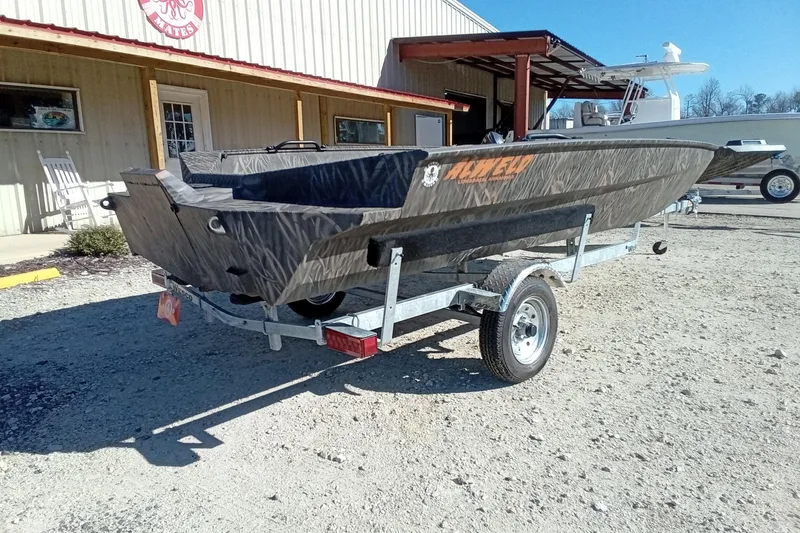 Slide: The Image of 2026 Alweld 1756 Invader boat on trailer outside a building, sunny day. - 9