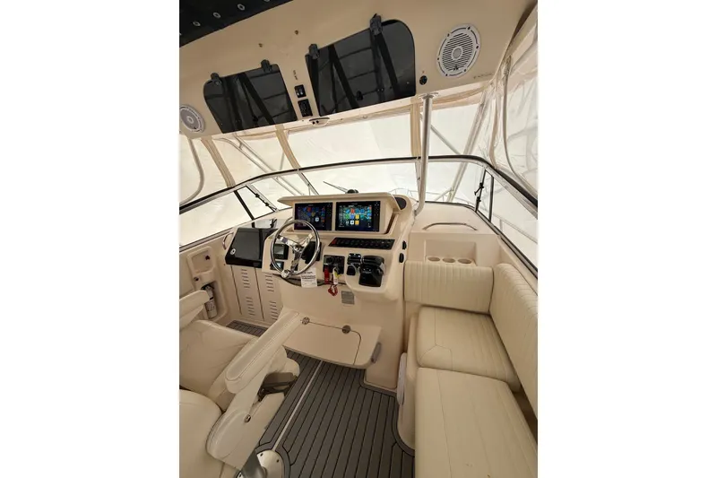 Slide: The Image of 2005 Grady-White Express 330 boat interior with steering wheel and navigation screens. - 10