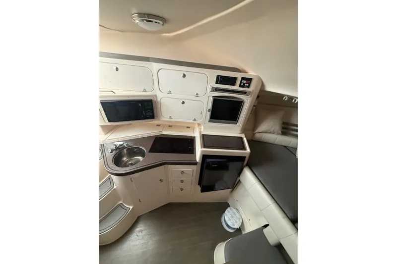 Slide: The Image of 2005 Grady-White Express 330 boat interior with kitchenette and seating area. - 16