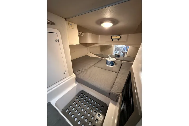 Slide: The Image of 2005 Grady-White Express 330 cabin interior with cushioned seating and storage. - 21