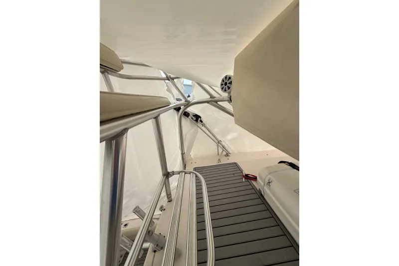 Slide: The Image of Interior view of 2005 Grady-White Express 330 boat, featuring sleek metal railings and cushioned seating. - 27