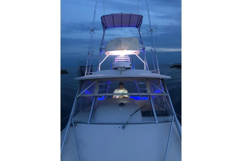 Slide: The Image of 2005 Grady-White Express 330 boat illuminated at dusk on calm waters. - 4