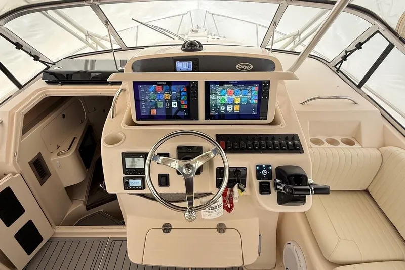 Slide: The Image of 2005 Grady-White Express 330 helm with dual displays and modern controls. - 5