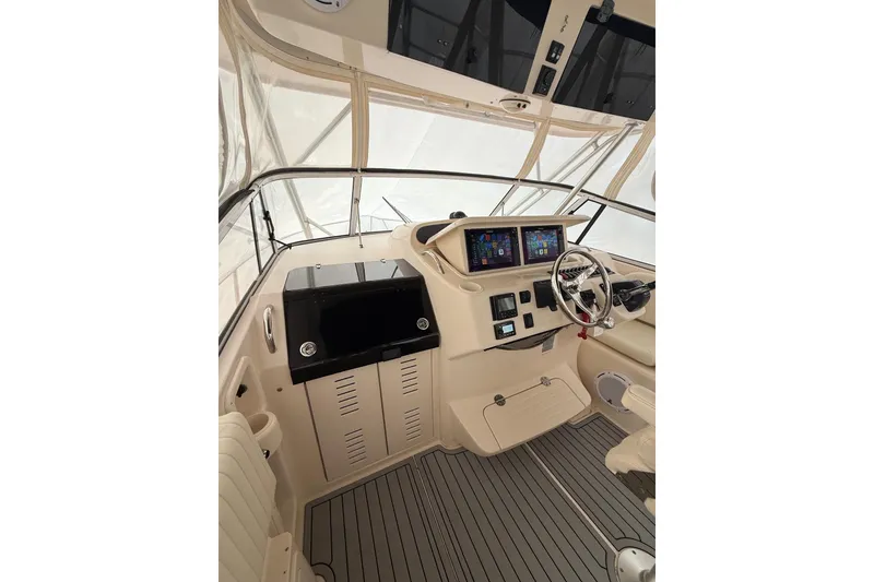 Slide: The Image of 2005 Grady-White Express 330 helm with modern navigation equipment and steering wheel. - 9