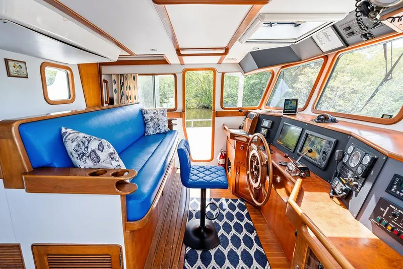 Slide: The Image of Luxurious Selene Solo 2000 yacht interior with blue seating, wooden accents, and advanced navigation equipment. - 18