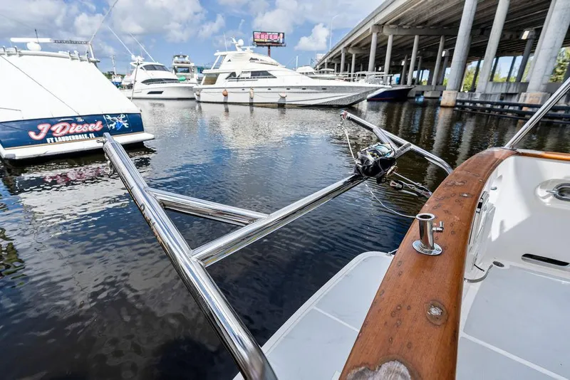 Slide: The Image of Docked boats at marina with Selene Solo 2000, featuring stainless steel bow and wooden rail. - 37