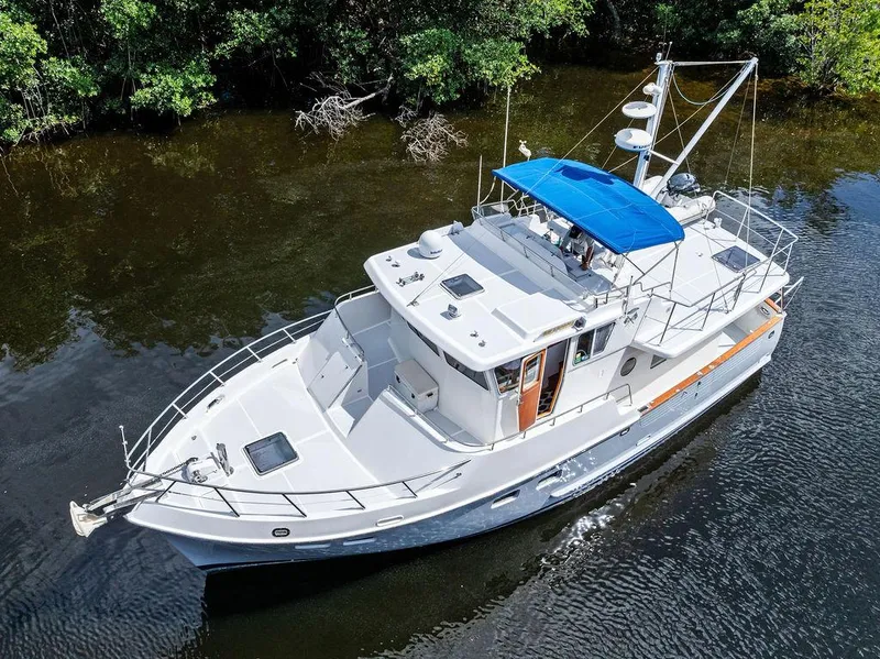 Slide: The Image of Selene Solo 2000 yacht with blue canopy cruising on a calm river. - 6