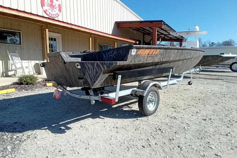 Slide: The Image of 2026 Alweld 1652 Invader boat on trailer, parked outside a building. - 10