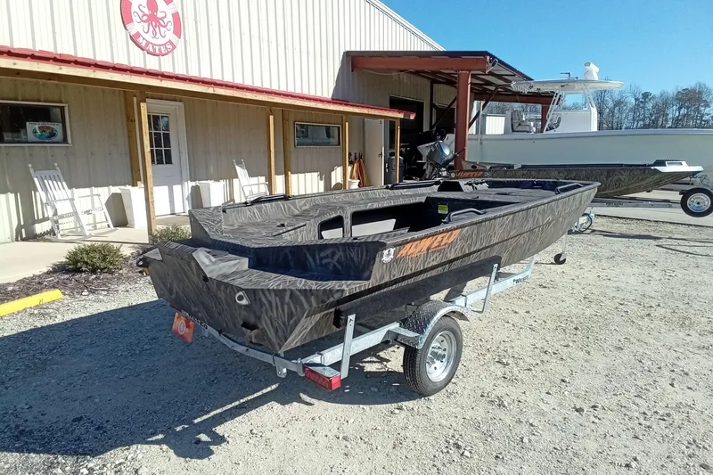 Slide: The Image of 2026 Alweld 1652 Invader boat on trailer outside a building, sunny day. - 11