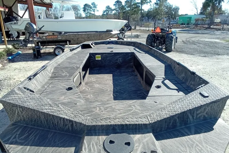 Slide: The Image of 2026 Alweld 1652 Invader boat with camouflage interior, parked outdoors. - 13