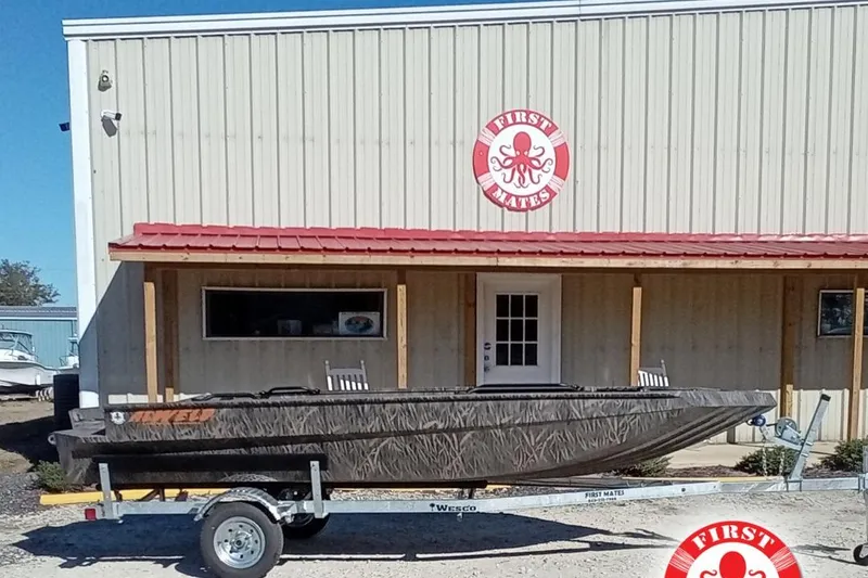 The Image of 2026 Alweld 1652 Invader boat on trailer outside First Mates building. - 2