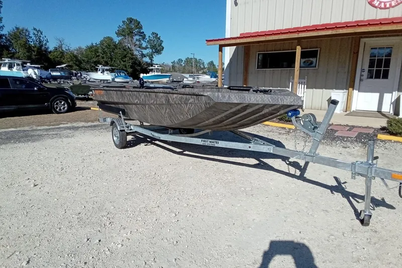 Slide: The Image of 2026 Alweld 1652 Invader boat on trailer, parked outside a building. - 4