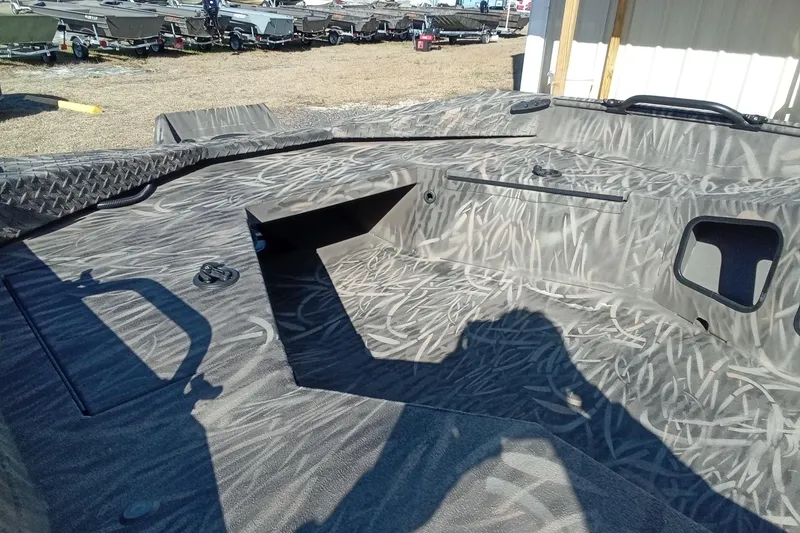 Slide: The Image of 2026 Alweld 1652 Invader boat interior with camouflage pattern and storage compartments. - 9