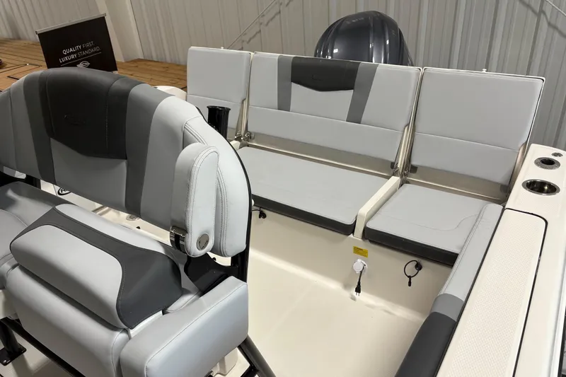 Slide: The Image of 2025 Robalo R232 Explorer boat interior with gray seating and modern design. - 12