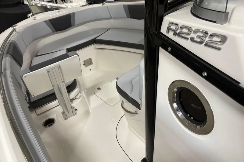 Slide: The Image of 2025 Robalo R232 Explorer boat interior with cushioned seating and sleek design. - 4