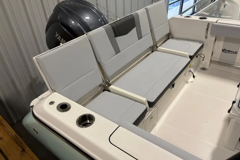Slide: The Image of 2025 Robalo R232 Explorer boat interior with seating and Yamaha engine. - 6