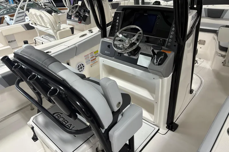 Slide: The Image of 2025 Robalo R232 Explorer boat interior with modern helm and seating. - 7
