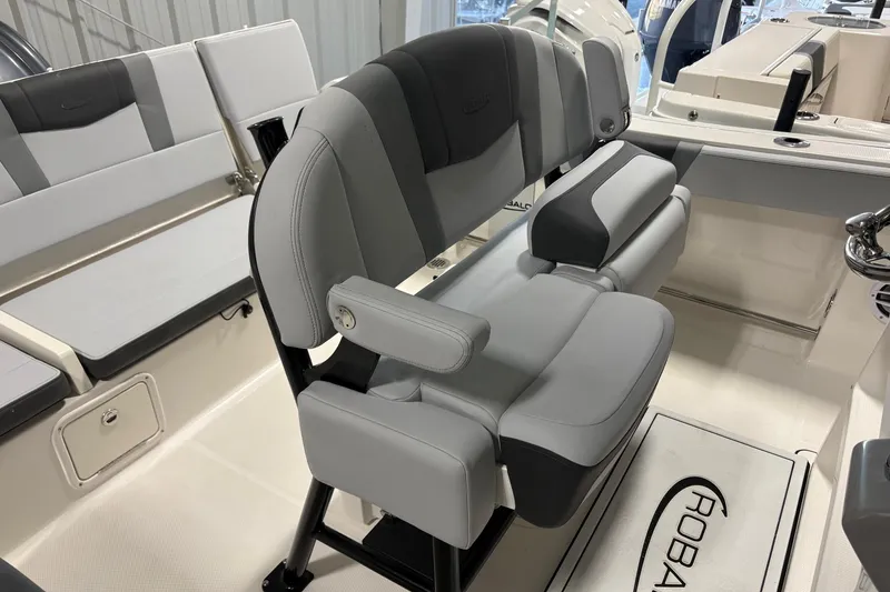 Slide: The Image of 2025 Robalo R232 Explorer boat interior with gray seating and helm station. - 9